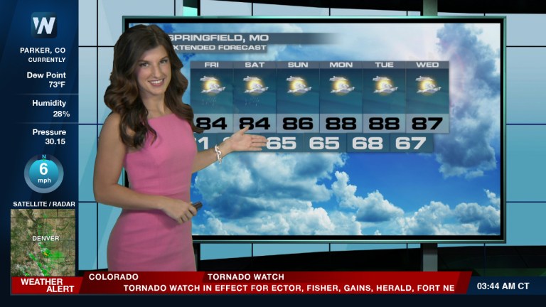 Weather lady in Parker, CO in front of radar in pink dress weather alert