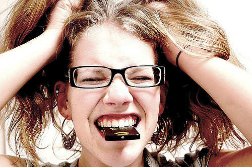 Angry woman with eyes closed and hands in hair